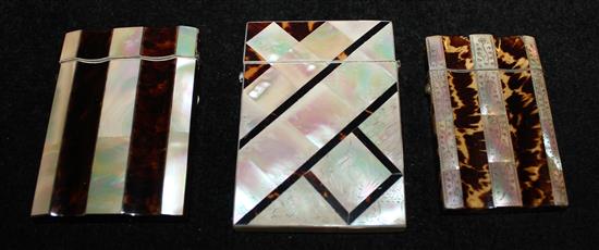 Three tortoiseshell and mother of pearl card cases, two vertically-banded, one engraved with a heron